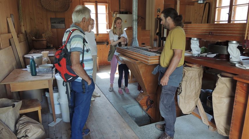 Stephen Palmer preschainta a gruppas interessadas co cha’l muglin da Tarasp funcziuna – sco per exaimpel in gövgia passada pro üna visita guidada (fotografia: Benedict Stecher).